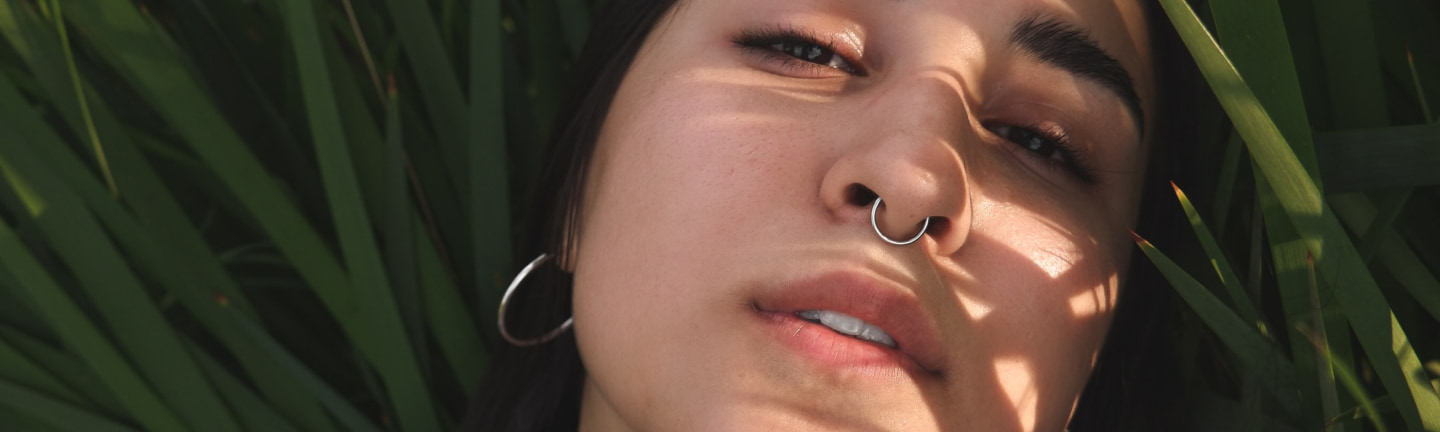 Model with nose and ear piercings